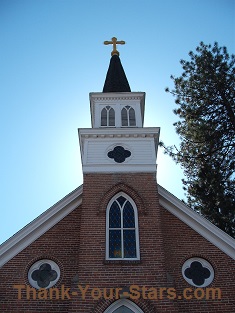 Brick Church Backlit by Sun in Blue Sky